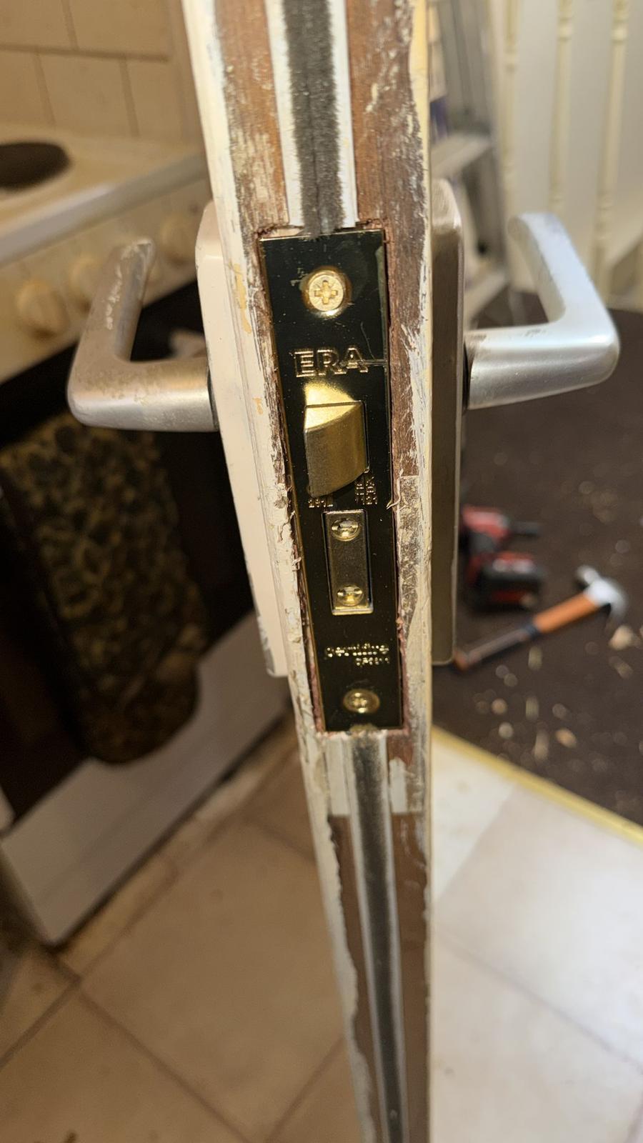 ERA lock plate fitted to a door during a lock change